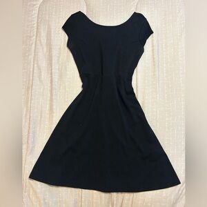 Black mini dress with tight waist and flowy bottom